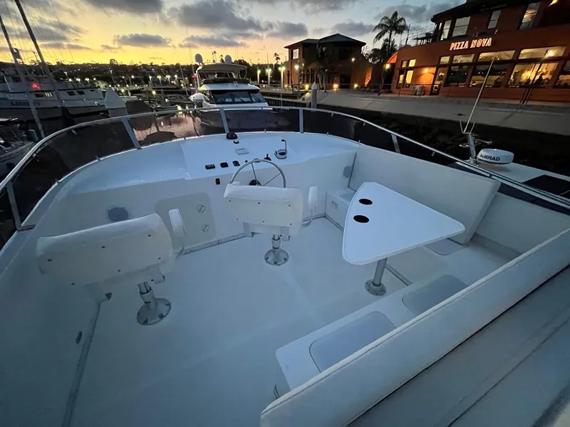 Slide: The Image of The image shows the deck of a 2027 Bracewell 41 boat. It features white seating and a table. - 56