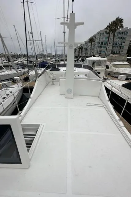 Slide: The Image of Bracewell 41 yacht deck, 2025 model, docked in a marina with surrounding boats. - 6