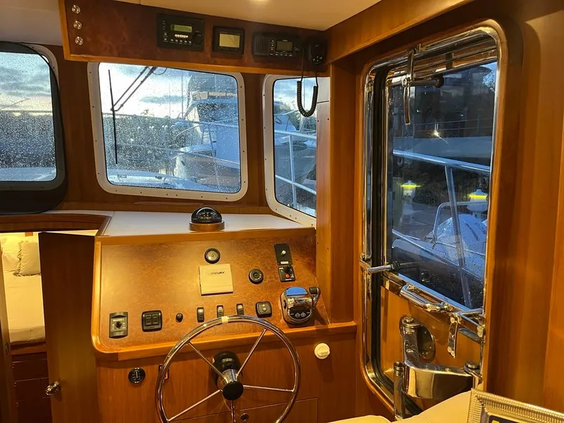 Slide: The Image of Interior of 2025 Bracewell 41 boat with wooden helm and navigation equipment. - 37
