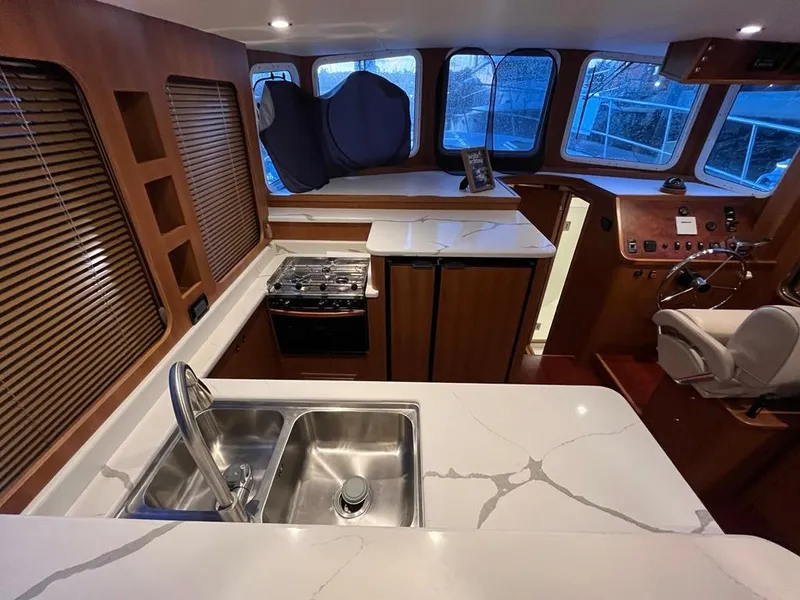 Slide: The Image of Modern kitchen interior of 2025 Bracewell 41 yacht with sleek countertops and stainless steel sink. - 31