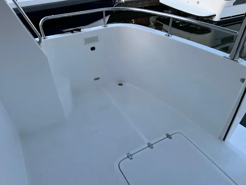 Slide: The Image of The image shows the clean, white deck of a 2027 Bracewell 41 boat. - 52
