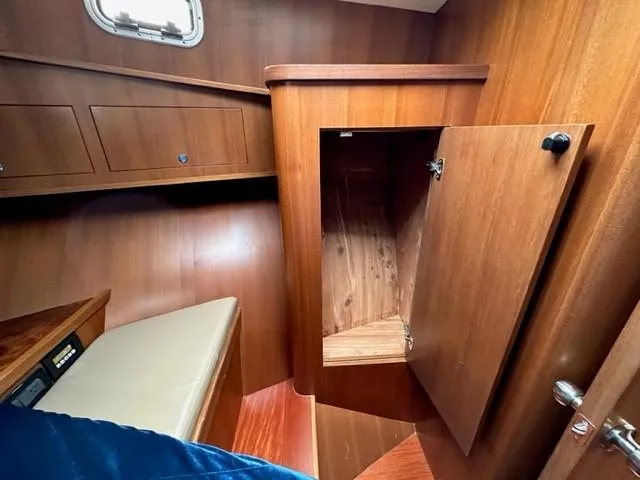 Slide: The Image of Cozy wooden cabin interior of 2025 Bracewell 41 boat with open storage. - 13