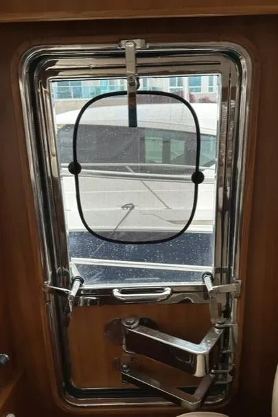 Slide: The Image of Bracewell 41 yacht window, 2025 model, with secure locking mechanism and exterior view. - 18