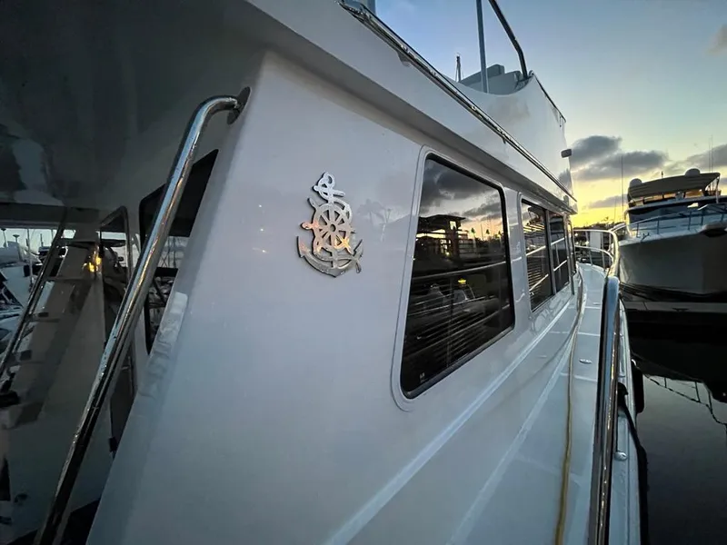 Slide: The Image of Side view of a white Bracewell 41 yacht docked at sunset. - 54