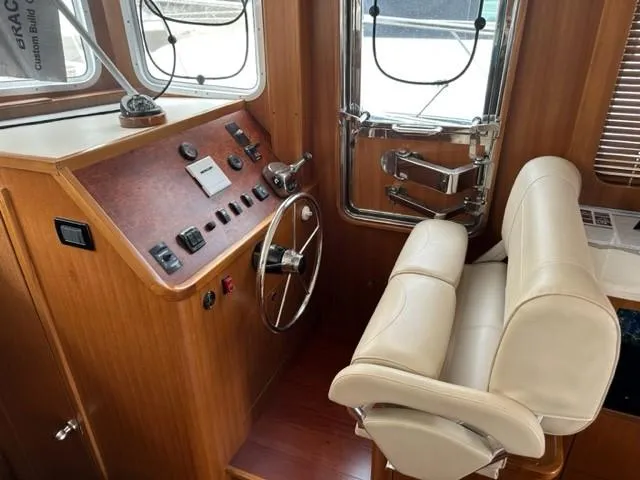 Slide: The Image of Interior helm of 2025 Bracewell 41 boat with steering wheel and controls. - 17