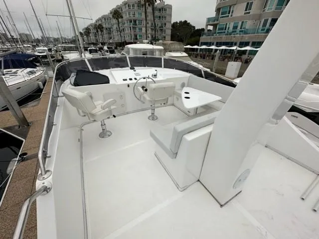 Slide: The Image of Flybridge of 2025 Bracewell 41 yacht with helm, seating, and table in marina setting. - 2
