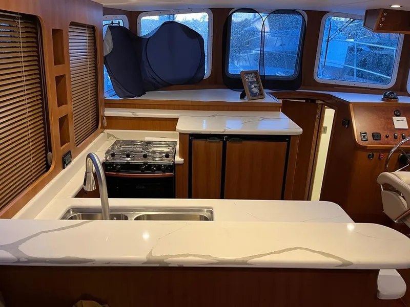 Slide: The Image of Luxurious Bracewell 41 yacht interior with modern kitchen, sleek countertops, and panoramic windows, 2025 model. - 30
