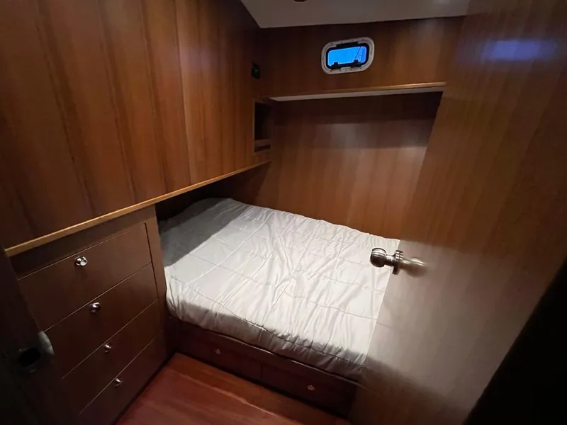 Slide: The Image of Cozy cabin interior of 2025 Bracewell 41 yacht with wooden paneling and bed. - 22