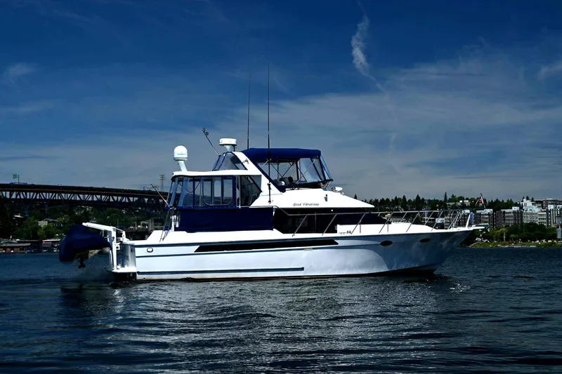 The Image of 1997 Ocean Alexander 440 Sundeck CPMY yacht on calm water under blue sky. - 1