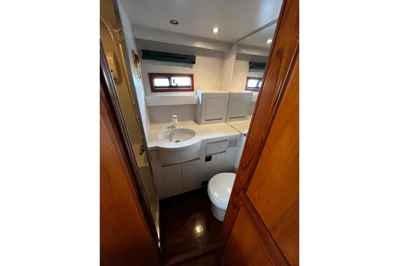 Slide: The Image of Bathroom interior of 1997 Ocean Alexander 440 Sundeck CPMY yacht, featuring sink and toilet. - 26