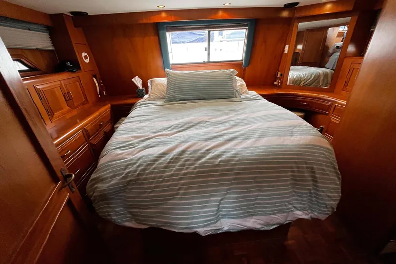 Slide: The Image of Cozy bedroom interior of 1997 Ocean Alexander 440 Sundeck CPMY yacht with wood paneling. - 23