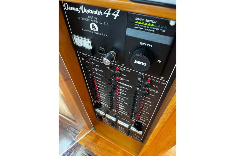 Slide: The Image of Control panel of a 1997 Ocean Alexander 440 Sundeck CPMY yacht, featuring switches and gauges. - 27
