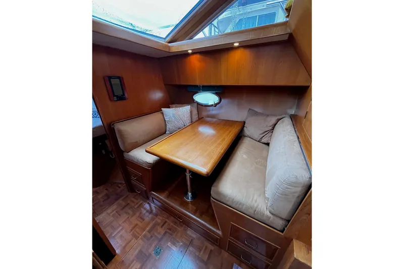 Slide: The Image of Cozy dining area in 1997 Ocean Alexander 440 Sundeck CPMY yacht with wood finish. - 18