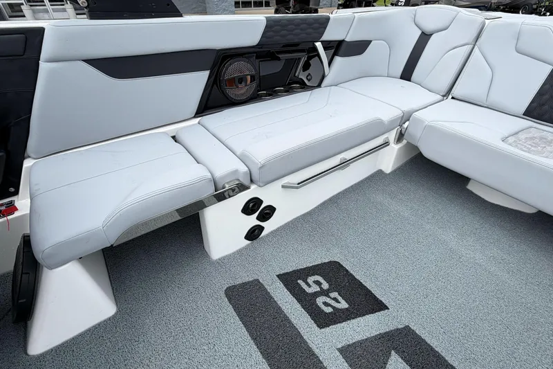 Slide: The Image of 2024 MasterCraft XT25 boat interior with sleek seating and integrated speaker system. - 31