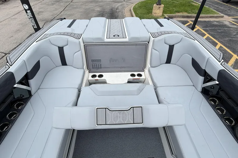 Slide: The Image of 2024 MasterCraft XT25 boat interior with luxurious seating and cup holders. - 29