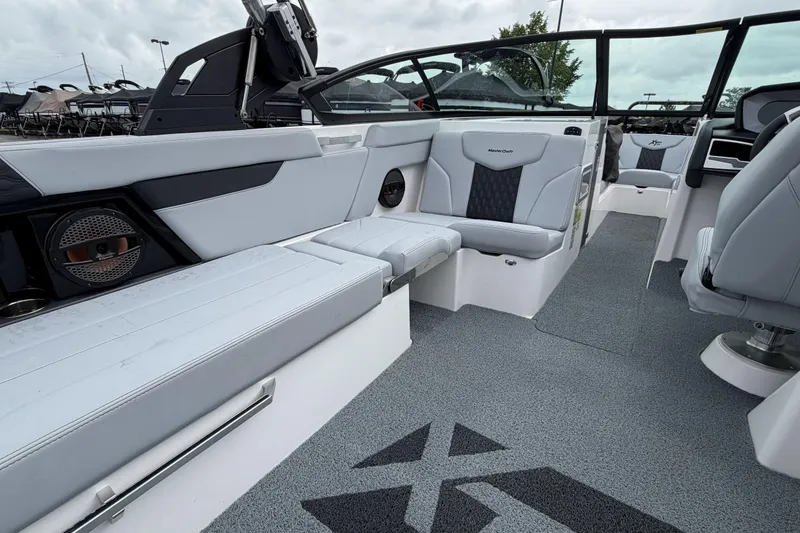 Slide: The Image of 2024 MasterCraft XT25 boat interior with sleek seating and modern design. - 23