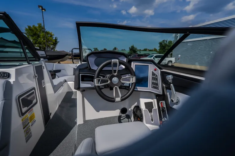 Slide: The Image of 2024 MasterCraft XT25 boat cockpit with modern steering and control panel. - 17