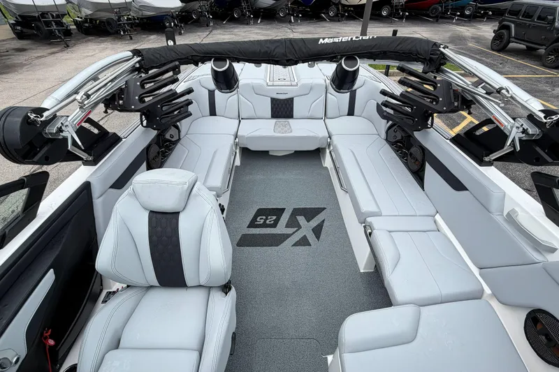 Slide: The Image of 2024 MasterCraft XT25 boat interior with sleek seating and advanced wakeboard racks. - 35