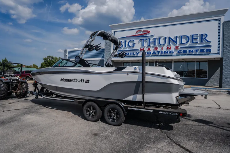 Slide: The Image of 2024 MasterCraft XT25 boat on trailer at Big Thunder Marine dealership. - 7