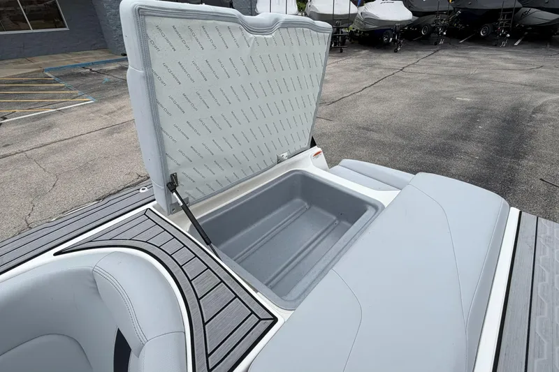 Slide: The Image of Open storage compartment on 2024 MasterCraft XT25 boat, showcasing interior space. - 40