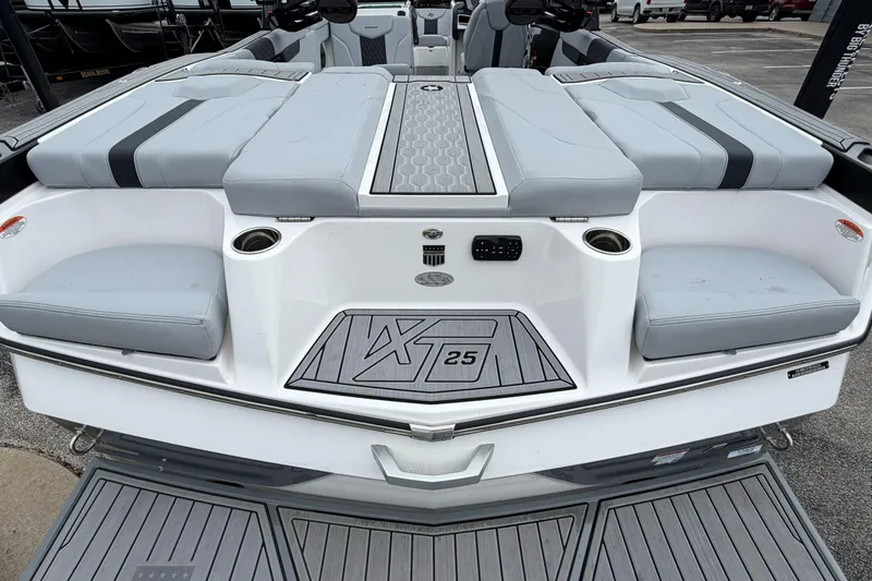 Slide: The Image of 2024 MasterCraft XT25 boat interior with gray seating and cup holders. - 41
