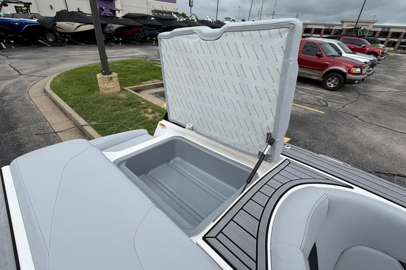 Slide: The Image of 2024 MasterCraft XT25 boat storage compartment open in a parking lot. - 39