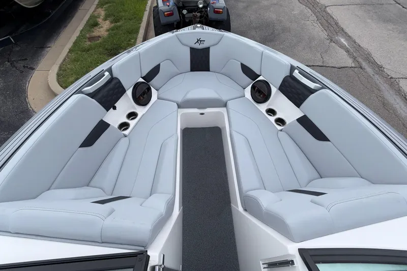 Slide: The Image of 2024 MasterCraft XT25 boat interior with luxurious seating and cup holders. - 10