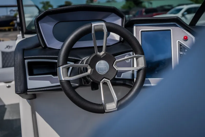 Slide: The Image of 2024 MasterCraft XT25 steering wheel and dashboard, featuring modern controls and sleek design. - 16