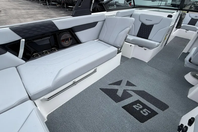 Slide: The Image of 2024 MasterCraft XT25 boat interior with sleek seating and custom flooring. - 22