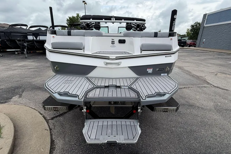 Slide: The Image of 2024 MasterCraft XT25 boat rear view with swim platform and seating. - 42