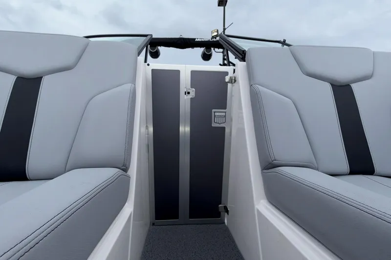 Slide: The Image of 2024 MasterCraft XT25 boat interior with sleek gray seating and modern design. - 3