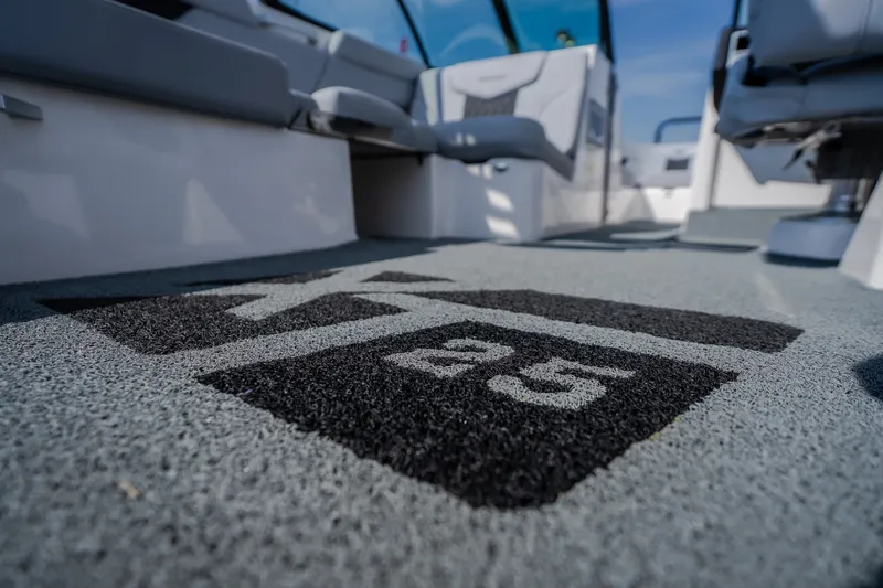 Slide: The Image of 2024 MasterCraft XT25 boat interior with logo on carpeted floor. - 15