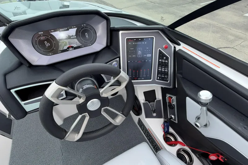 Slide: The Image of 2024 MasterCraft XT25 dashboard with modern steering wheel and digital controls. - 17