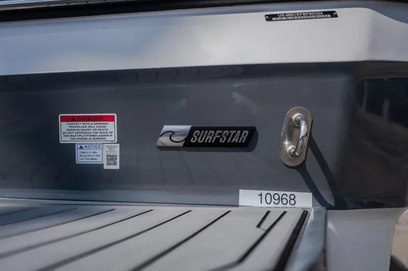 Slide: The Image of 2024 MasterCraft XT25 boat with SurfStar logo and safety warnings on the stern. - 3