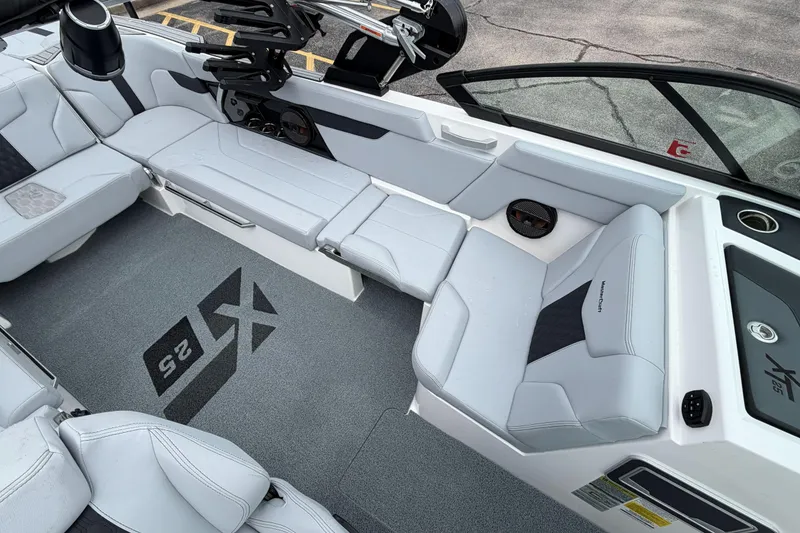Slide: The Image of 2024 MasterCraft XT25 boat interior with sleek seating and modern design. - 33