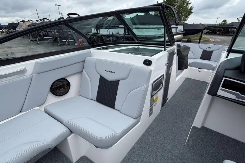 Slide: The Image of 2024 MasterCraft XT25 boat interior with sleek seating and modern design. - 38