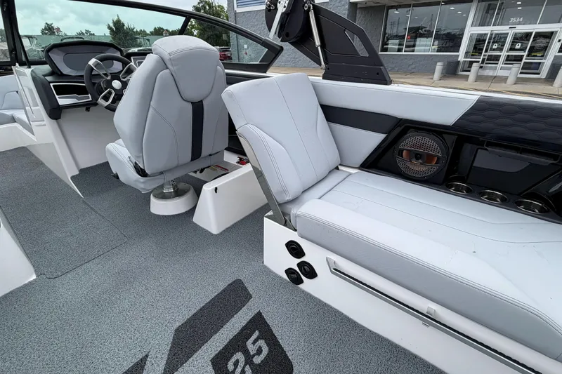 Slide: The Image of 2024 MasterCraft XT25 boat interior with modern seating and dashboard design. - 24