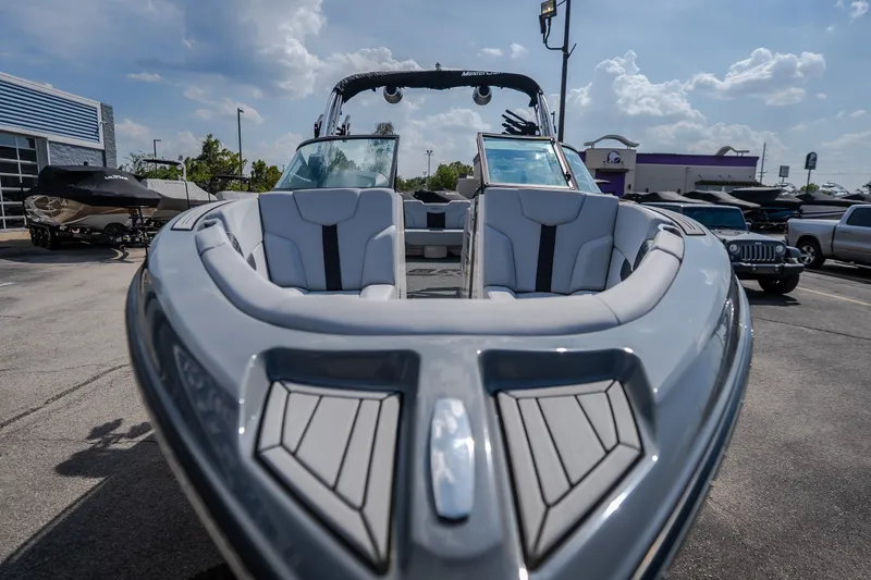 Slide: The Image of 2024 MasterCraft XT25 boat with sleek design, parked outdoors under a sunny sky. - 8
