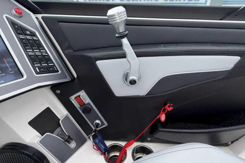 Slide: The Image of 2024 MasterCraft XT25 boat dashboard with control panel and throttle lever. - 14