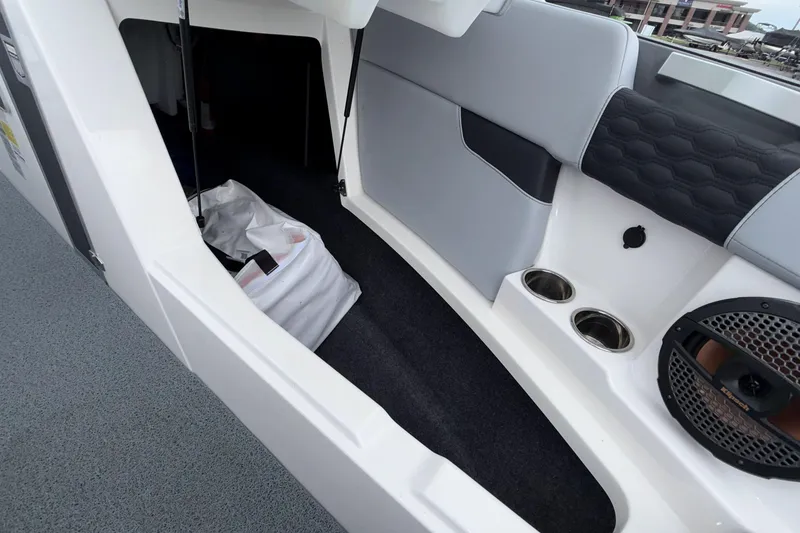 Slide: The Image of 2024 MasterCraft XT25 boat interior with storage compartment and speaker system. - 9