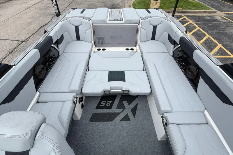 Slide: The Image of 2024 MasterCraft XT25 boat interior with spacious seating and modern design. - 27