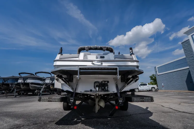 Slide: The Image of 2024 MasterCraft XT25 boat rear view under a clear blue sky. - 5