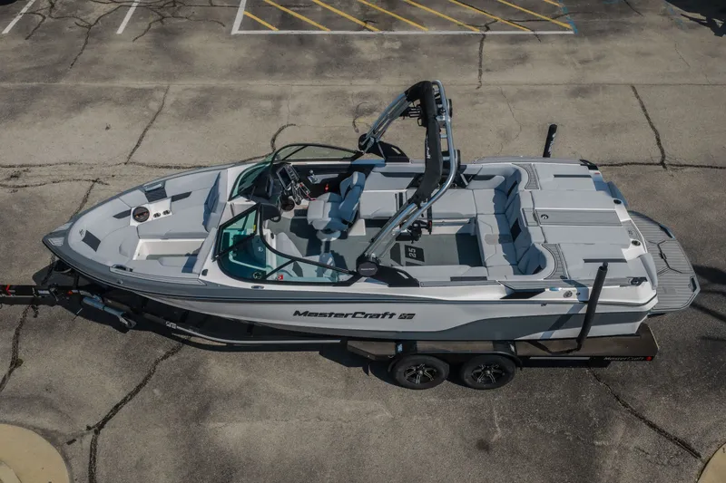 Slide: The Image of 2024 MasterCraft XT25 boat on trailer, aerial view in parking lot. - 24