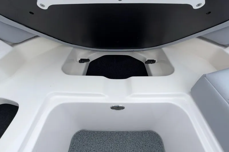 Slide: The Image of 2024 MasterCraft XT25 boat interior storage compartment, featuring sleek white and gray design. - 7