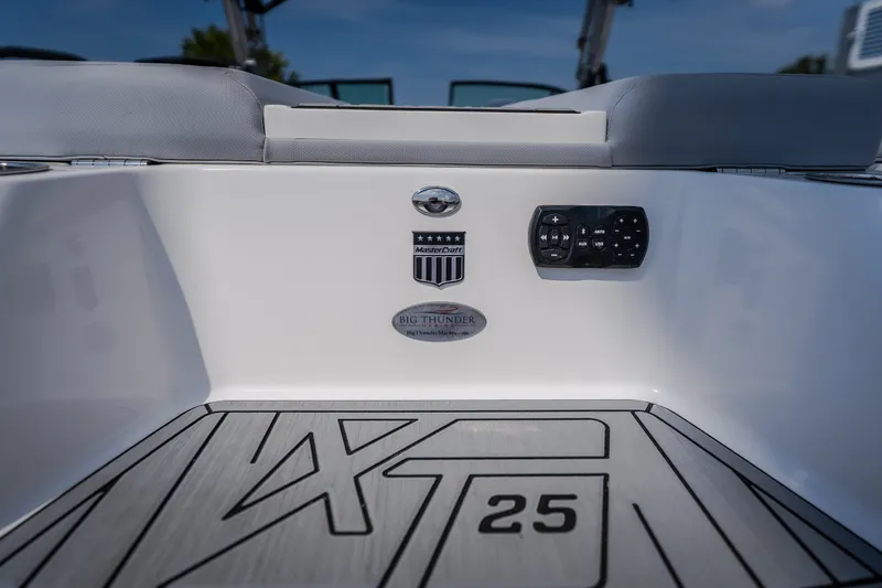 Slide: The Image of 2024 MasterCraft XT25 boat interior with control panel and branding details. - 13