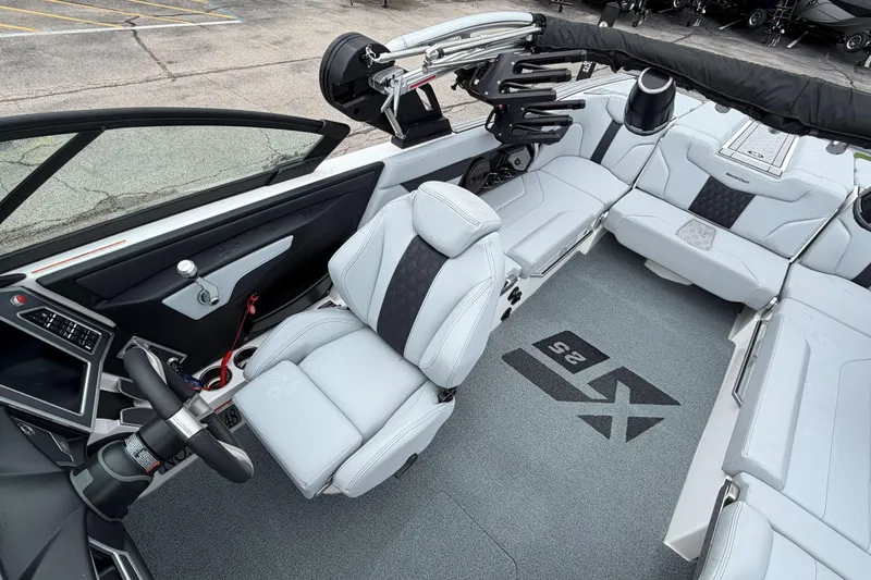 Slide: The Image of 2024 MasterCraft XT25 boat interior with luxurious seating and modern dashboard design. - 34