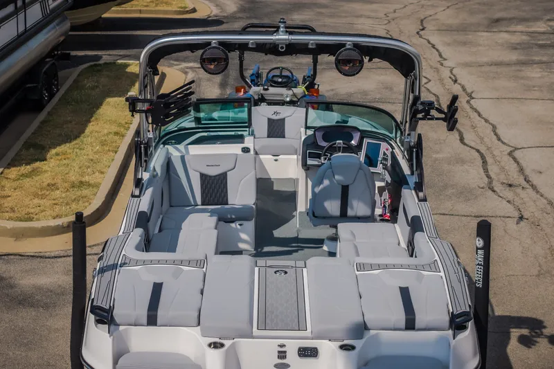 Slide: The Image of 2024 MasterCraft XT25 boat interior with sleek seating and modern dashboard design. - 26