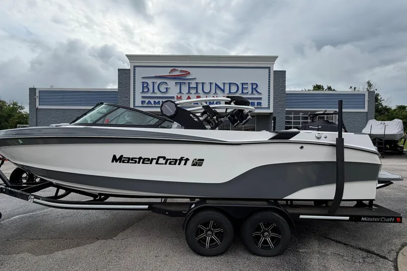 The Image of 2024 MasterCraft XT25 boat on trailer at Big Thunder Marine dealership. - 1