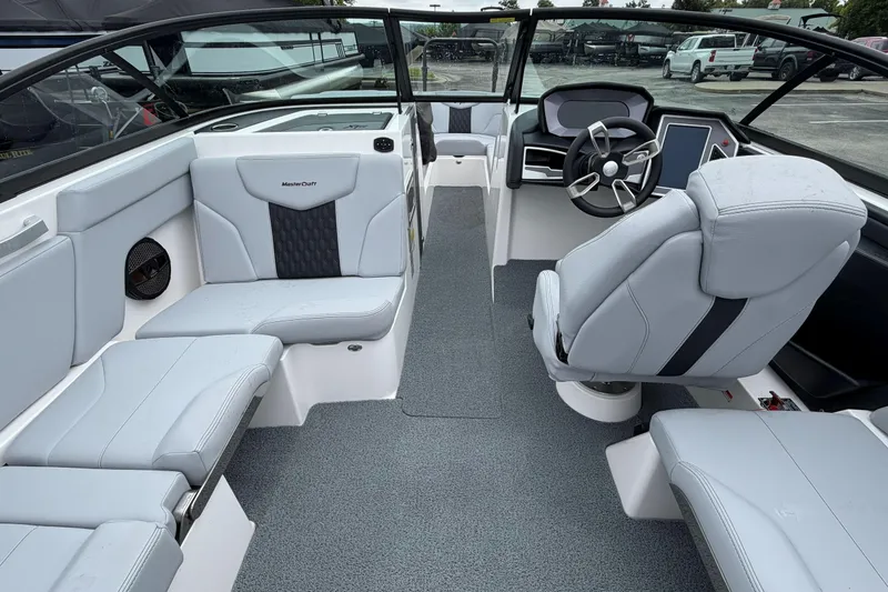 Slide: The Image of 2024 MasterCraft XT25 boat interior with modern seating and steering console. - 36