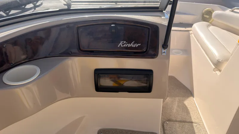 Slide: The Image of The image shows the cockpit of a 2002 Rinker 192 Captiva Bowrider with a cup holder and speaker. - 27